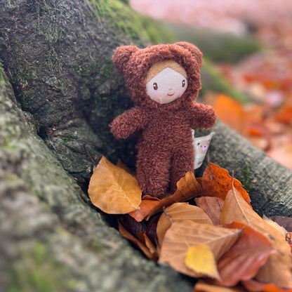 Threadbear Design Heidi Bear Little Peeps Doll in the garden.  A pocket size soft toy doll wearing a furry bear suit.  Perfect for dolls houses and imaginative play.