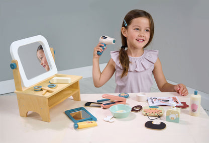 Child playing with wooden pretend play hair salon.