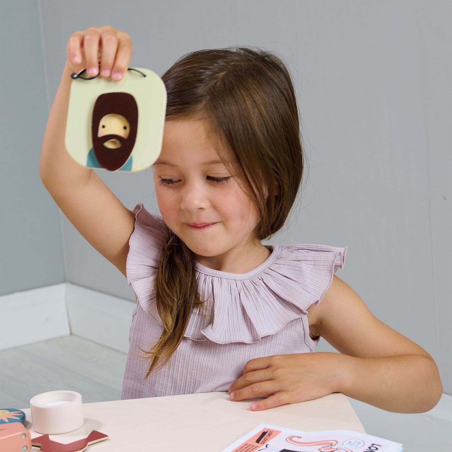 Child playing with wooden pretend play hair salon.  